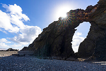 Majestic Arco del Juradonatural arch lit by sun on Pena Horadada beach, Betancuria, Fuerteventura, Canary Islands, Spain, Atlantic, Europe