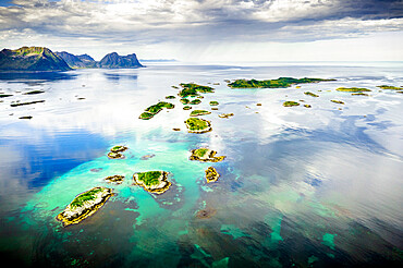 Cloudy sky over Bergsoyan Islands in the clear water of the fjord, Hamn I Senja, Skaland, Senja, Troms county, Norway, Scandinavia, Europe