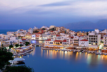 Agios Nikolaos old town with lake in its centre at dusk, Lasithi prefecture, Crete, Greek Islands, Greece, Europe