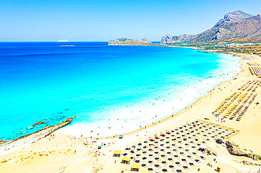 Beach umbrellas and sunbeds on white sand of Falassarna beach overlooking the crystal sea, Kissamos, Chania, Crete, Greek Islands, Greece, Europe