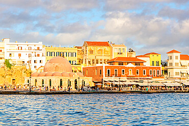 Tourists enjoying sunset at the old Venetian port of Chania, Crete, Greek Islands, Greece, Europe