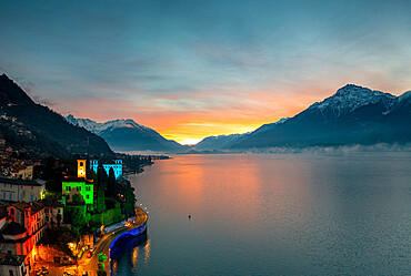 Christmas lights decorating the old bell tower and houses in Gravedona during sunrise, Lake Como, Lombardy, Italian Lakes, Italy, Europe