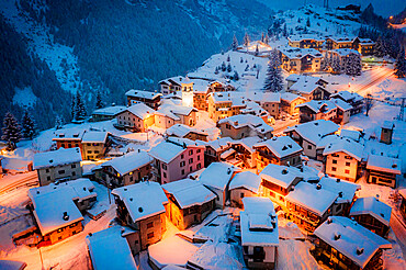 Christmas lights on mountain houses and chalets covered with snow at dusk, Pianazzo, Madesimo, Valle Spluga, Valtellina, Lombardy, Italy, Europe