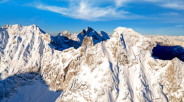 Majestic rock pinnacles of Pioda Di Sciora peak covered with snow, aerial view, Val Bregaglia, Graubunden Canton, Switzerland, Europe