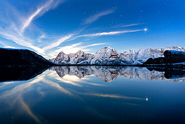 Eiger, Monch and Jungfrau mountains mirrored in Engital lake under the stars, Murren Birg, Bern Canton, Swiss Alps, Switzerland, Europe