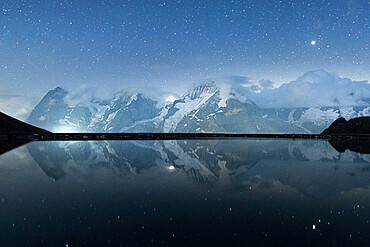 Engital lake under the starry sky with Eiger, Monch and Jungfrau mountains in the background, Murren Birg, Bern Canton, Swiss Alps, Switzerland, Europe