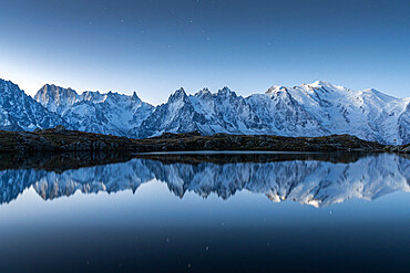 Lacs des Cheserys lake and peaks of Mont Blanc massif covered with snow at night, Chamonix, Haute Savoie, French Alps, France, Europe