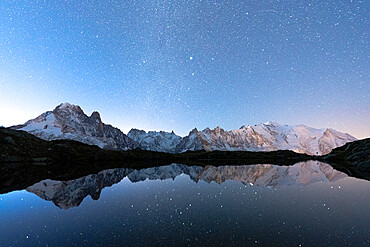 Starry sky over the snowcapped Mont Blanc, Grand Jorasses, Aiguille Vert reflected in Lacs de Cheserys, Haute Savoie, French Alps, France, Europe