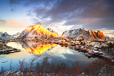 Dramatic sky at dawn over Mount Olstind covered with snow, Reine Bay, Nordland, Lofoten Islands, Norway, Scandinavia, Europe