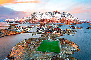 Aerial view of soccer stadium and Henningsvaer village during winter dawn, Nordland county, Lofoten Islands, Norway, Scandinavia, Europe