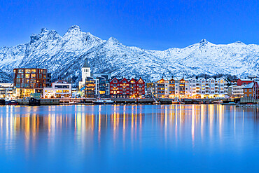 Coastal town of Svolvaer framed by snowcapped mountains at dusk, Nordland county, Lofoten Islands, Norway, Scandinavia, Europe