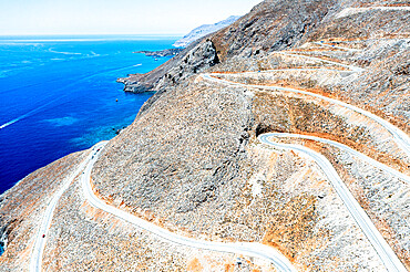 Hairpin bends of mountain road leading to the blue sea, aerial view, Crete island, Greek Islands, Greece, Europe