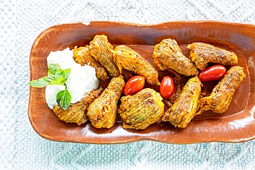 Traditional fried stuffed zucchini flowers with Tzatziki sauce, Crete island, Greek Islands, Greece, Europe