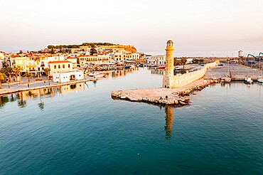 Aerial view of the calm sea at dawn surrounding the old Venetian port and lighthouse, Rethymno, Crete island, Greek Islands, Greece, Europe