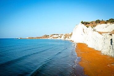 Sunrise over the gold sand of Xi beach surrounded by majestic limestone cliffs, Kefalonia, Ionian Islands, Greek Islands, Greece, Europe