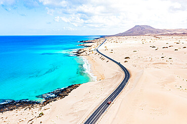 Aerial view of road crossing the desert overlooking the crystal sea, Corralejo Natural Park, Fuerteventura, Canary Islands, Spain, Atlantic, Europe