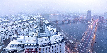 Aerial view of traditional houses and bridges along River Main during a snow storm in winter, Frankfurt, Hesse, Germany Europe