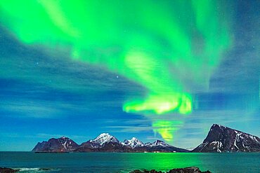 Bright green lights of Aurora Borealis reflecting in the sea, Myrland, Leknes, Vestvagoy, Lofoten Islands, Norway