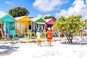 Mother with little boy looking at the colorful beach huts selling souvenirs, Antigua, Leeward Islands, Caribbean, West Indies