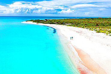 Man and woman running happy hand in hand on idyllic beach during honeymoon, overhead view, Barbuda, Antigua and Barbuda, West Indies, Caribbean, Central America