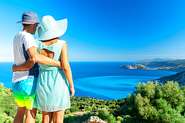 Man and woman in love embracing looking at the crystal sea, Myrtos beach, Kefalonia, Ionian Islands, Greek Islands, Greece, Europe