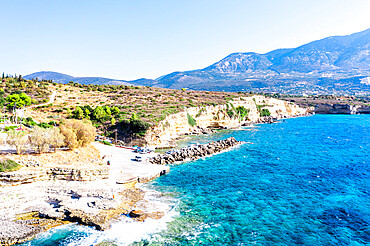 Waves of the turquoise sea crashing on rocks at the small harbour of Pessada, aerial view, Kefalonia, Ionian Islands, Greek Islands, Greece, Europe