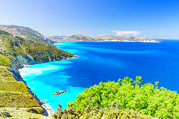 Lush plants on coastline above the turquoise lagoon surrounding Myrtos beach, Kefalonia, Ionian Islands, Greek Islands, Greece, Europe