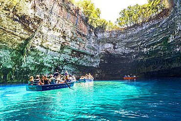 Tourists enjoying a boat trip into the cave at famous Melissani Lake, Kefalonia, Ionian Islands, Greek Islands, Greece, Europe