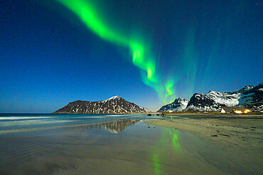 Northern Lights (Aurora Borealis) over snowcapped mountains overlooking Skagsanden beach, Ramberg, Nordland county, Lofoten Islands, Norway, Scandinavia, Europe