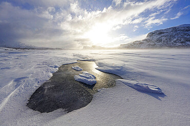 Clouds at sunset over a frozen lake covered with snow after a blizzard, Stora Sjofallet, Norrbotten County, Lapland, Sweden, Scandinavia, Europe