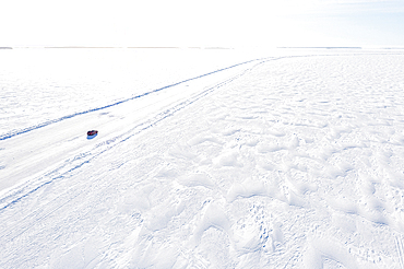 Aerial view of car driving on a slippery ice road on the frozen Arctic sea, Lulea, Norrbotten County, Lapland, Sweden, Scandinavia, Europe