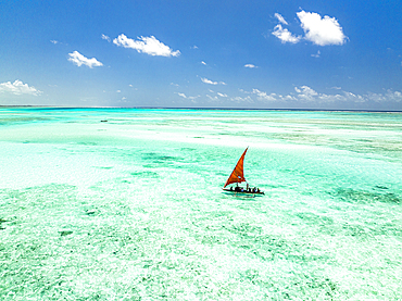 Tourists enjoying a boat trip on traditional dhow in the crystal sea, Paje, Jambiani, Zanzibar, Tanzania, East Africa, Africa