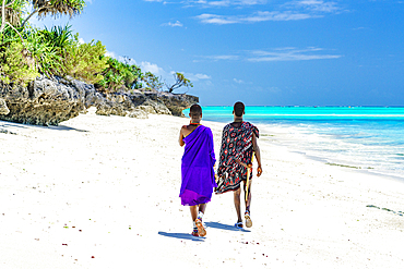 Couple of Maasai warriors enjoying walking on exotic beach, Zanzibar, Tanzania, East Africa, Africa