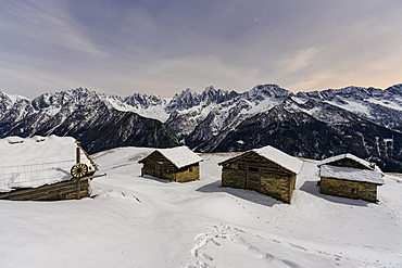 Mountain huts covered with snow at night, Tombal, Soglio, Val Bregaglia, canton of Graubunden, Switzerland, Europe