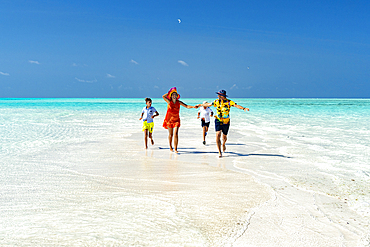 Family with two boys having fun running together on idyllic beach, Zanzibar, Tanzania, East Africa, Africa