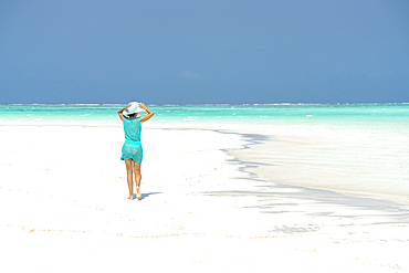 Woman walking on idyllic empty beach, Zanzibar, Tanzania, East Africa, Africa