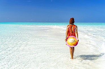 Mid adult woman enjoying walking on a beach, Zanzibar, Tanzania, East Africa, Africa