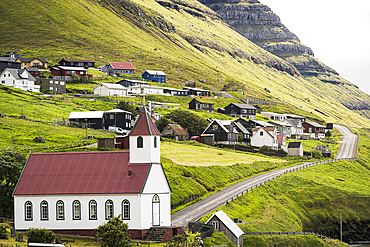 Traditional houses and church in the coastal village of Kunoy in summer, Kunoy Island, Faroe Islands, Denmark, Europe