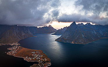 Storm clouds at sunset over majestic mountains along a fjord, aerial view, Reine Bay, Lofoten Islands, Nordland, Norway, Scandinavia, Europe