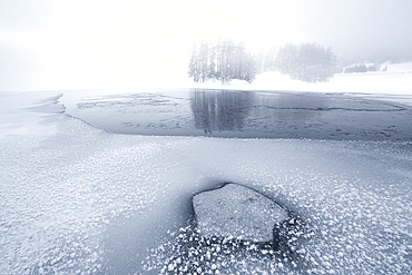 Foggy sky over the frozen Lake Champfer in winter, Engadine, Canton of Graubunden, Switzerland, Europe