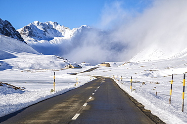 The road runs through the snow covered valley, Albula Pass, Engadine, Graubunden, Switzerland, Europe