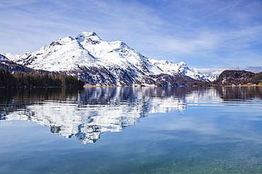 Piz da la Margna is reflected in the clear water of Lake Sils, Maloja Pass, Engadine, Canton of Graubunden, Switzerland, Europe