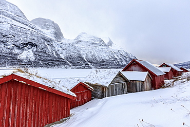 Typical wooden huts in the snowy landscape of Lyngseidet, Lyngen Alps, Tromso? Lapland, Norway, Scandinavia, Europe