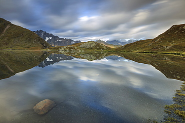 The snowy peaks are reflected in Fenetre Lakes at dawn, Ferret Valley, Saint Rhemy, Grand St Bernard, Aosta Valley, Italy, Europe