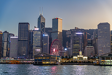 Highrise buildings in Victoria harbour at sunset, Hong Kong, China, Asia