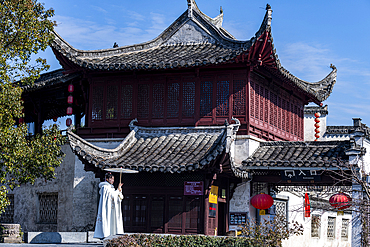 Woman posing in front of an old house, Xidi historical village, UNESCO World Heritage Site, Anhui, China, Asia