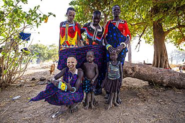 Pretty Mundari girls in traditional dresses posing with their children, Mundari tribe, South Sudan, Africa