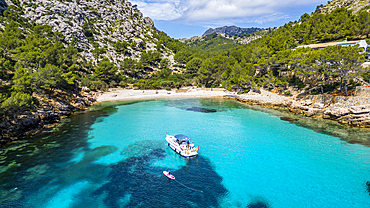 Aerial of a little motorboat in a bay on the Formentor Peninsula, Mallorca, Balearic islands, Spain, Mediterranean, Europe