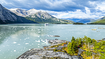 Aerial of a cruise ship anchoring below Pia glacier, Tierra del Fuego, Chile, South America