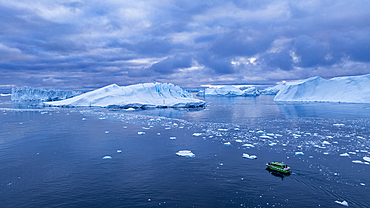 Aerial of a boat in the Ilulissat Icefjord, UNESCO World Heritage Site, Western Greenland, Denmark, Polar Regions